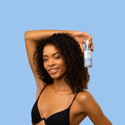 Model holding the Coconut Water Tanning Mist