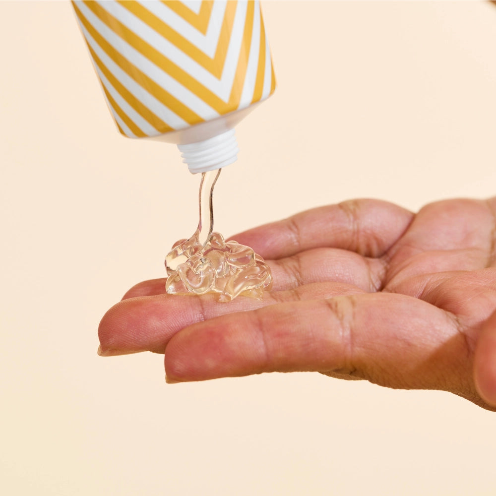 Model pouring After Glow Gloss formula onto hand